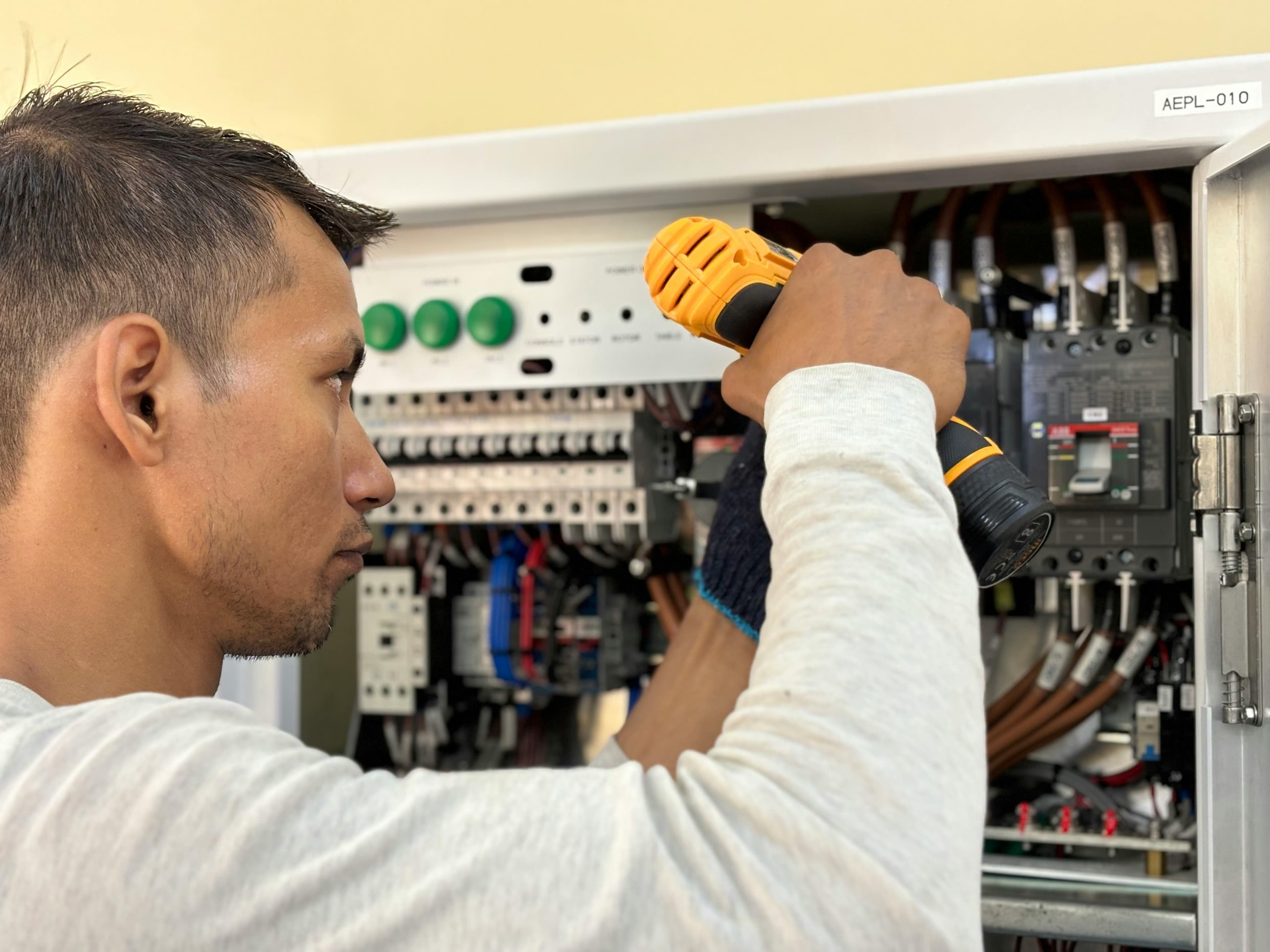 Electrician installing switchboard
